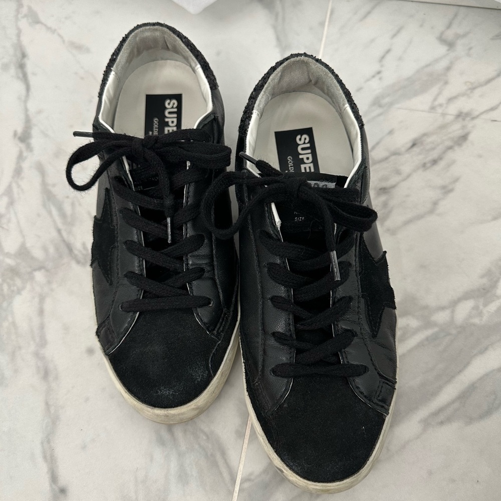 Golden goose super star in black nappa with black star and glitter heel tab.